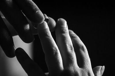 Close-up of human hand against black background