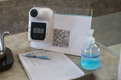 High angle view of mobile phone and book on table