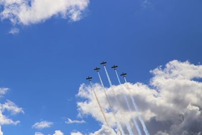 Low angle view of airshow against sky