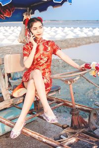 Portrait of young woman sitting outdoors