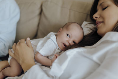 High angle view of baby girl sleeping on bed at home