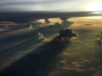 Sunlight streaming through clouds during sunset