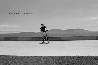 Man riding bicycle on road