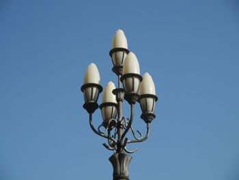 Low angle view of lamp post against clear blue sky