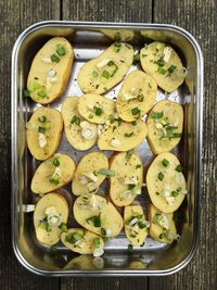 Directly above shot of food in baking sheet on wooden table