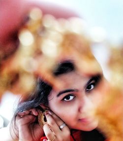 Close-up portrait of young woman wearing earring