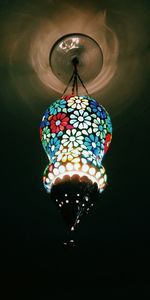 Close-up of illuminated pendant light hanging from ceiling