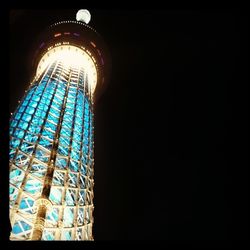 Low angle view of tower at night