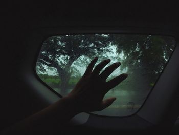 Reflection of person hand on glass window