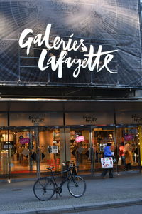 Bicycle sign on restaurant in city