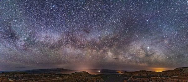 Scenic view of landscape against star field