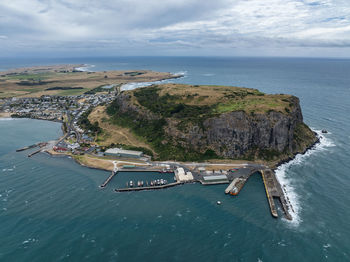 Aerial drone view of landmark the nut and the town of stanley on the north-west coast of tasmania.