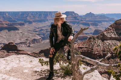 Man standing on rock against mountains