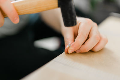 Cropped hand of man working on table