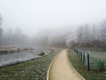 Scenic view of landscape against sky during foggy weather