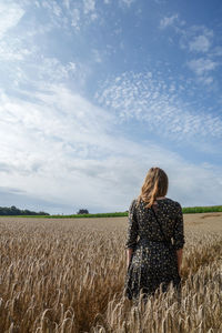 Rear view of woman standing on field