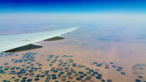 Low angle view of airplane wing against sky