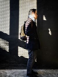 Side view of young man walking in city