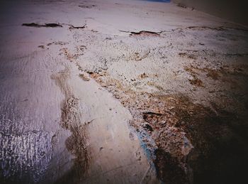 High angle view of wet puddle on beach