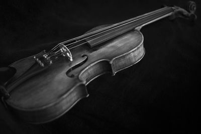 Close-up of violin over black background