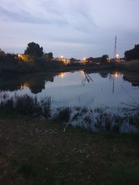 Scenic view of lake against sky at sunset