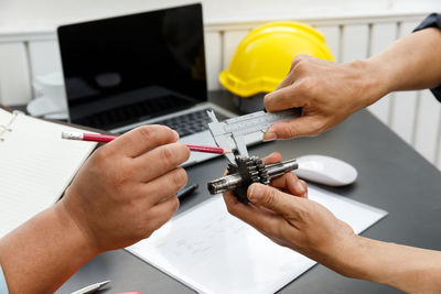 Midsection of man working on table