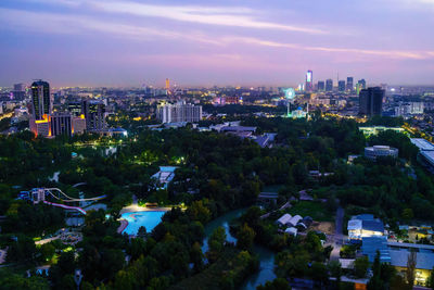 High angle view of illuminated cityscape against sky at night