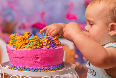 Close-up of cute baby eating cake