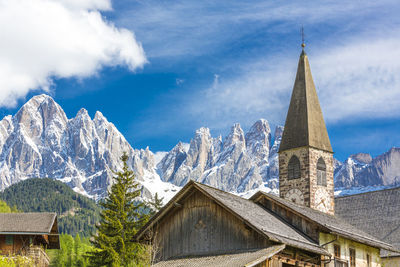 Church by mountain against sky