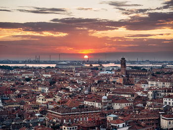 Aerial view of cityscape against sky during sunset