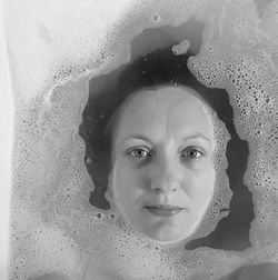 Portrait of young woman in bathtub