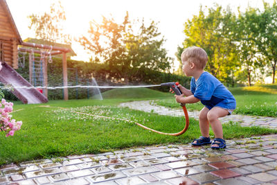 Full length of boy playing in water