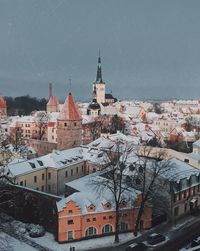 Buildings in city against sky during winter