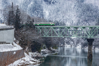 Bridge over river during winter