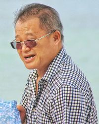 Close-up of senior man wearing eyeglasses at home