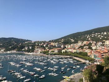 Aerial view of townscape by sea against clear blue sky, lerici