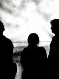 Rear view of silhouette people against sky