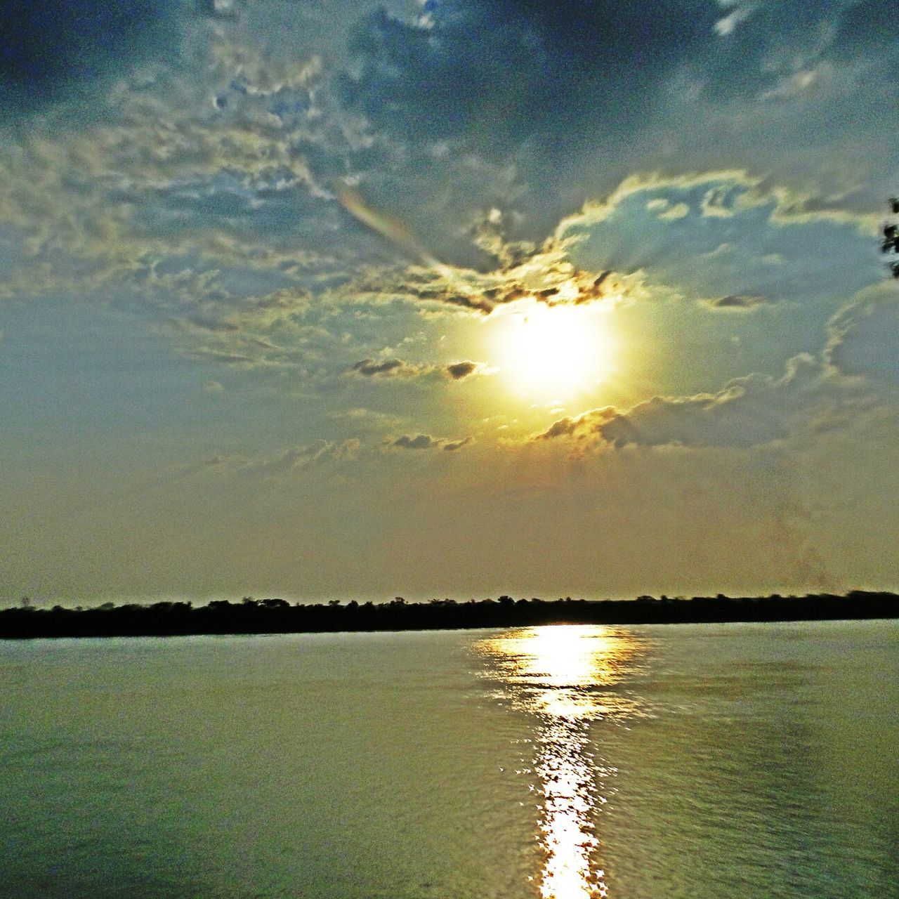 sun, water, reflection, tranquil scene, scenics, tranquility, beauty in nature, sky, sunset, sunlight, lake, sunbeam, nature, waterfront, idyllic, silhouette, lens flare, cloud - sky, rippled, outdoors