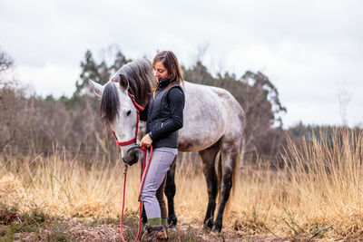 Horse standing on field against sky