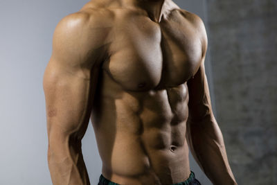 Midsection of shirtless muscular man