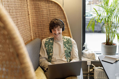 Young man using laptop in cafe