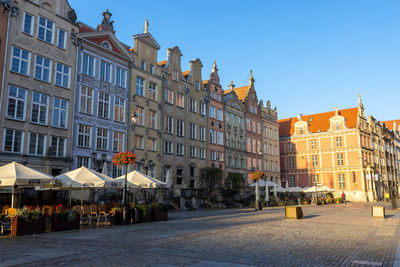 Buildings in city against blue sky