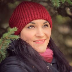 Portrait of smiling young woman in park during winter