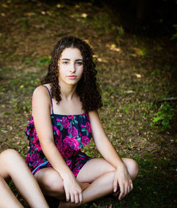 Portrait of a young woman sitting outdoors