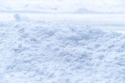 Close up of snow pile alongside a road