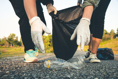 Low section of volunteers cleaning garbage from road