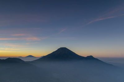 Scenic view of snowcapped mountains against sky during sunset