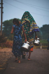 Rear view of people walking outdoors