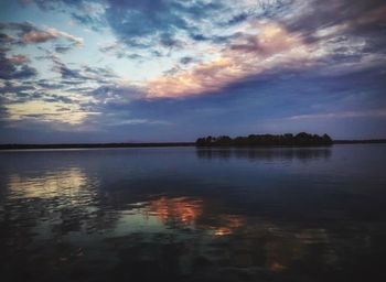 Scenic view of lake against sky at sunset