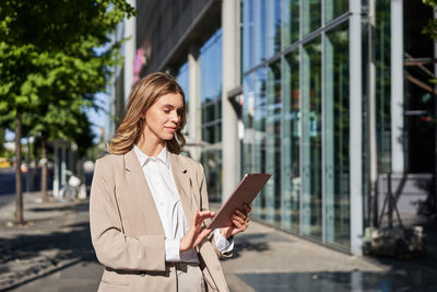 Portrait of young woman using mobile phone